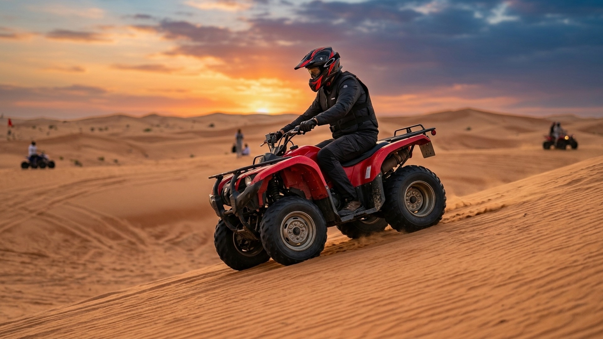 Yamaha quad rider crossing dunes at dusk