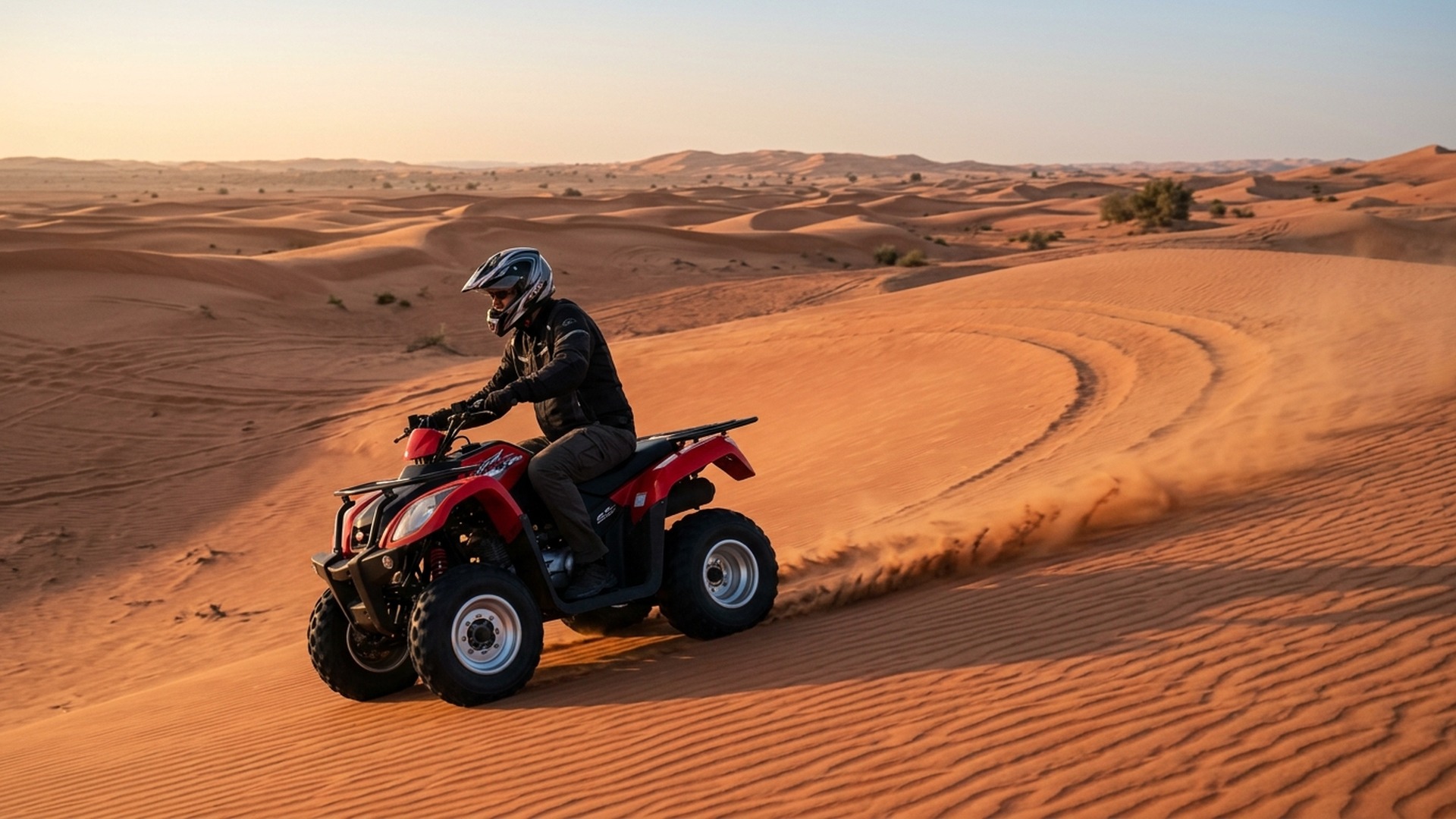 Yamaha quad climbing a soft red dune at Lahbab Desert