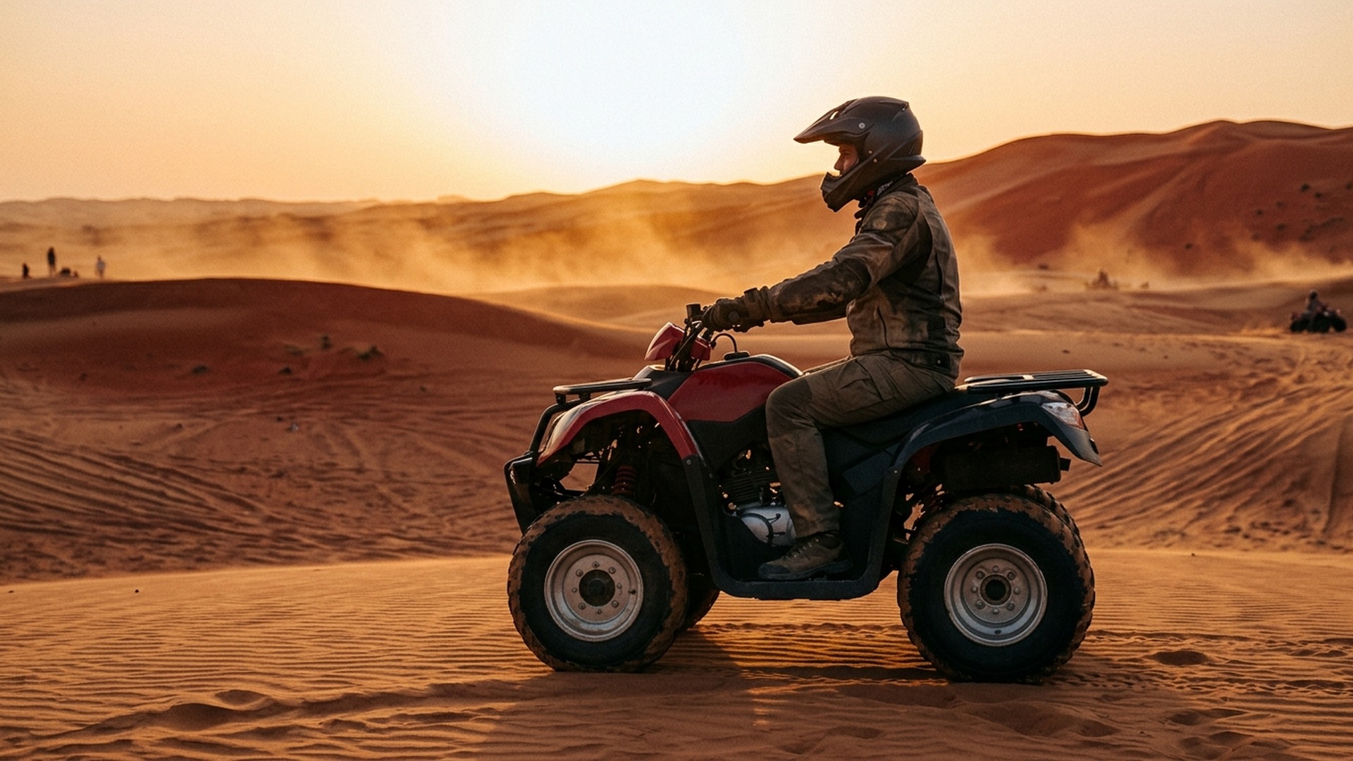 Quad rider on Yamaha wearing helmet and goggles at sunset Lahbab dune