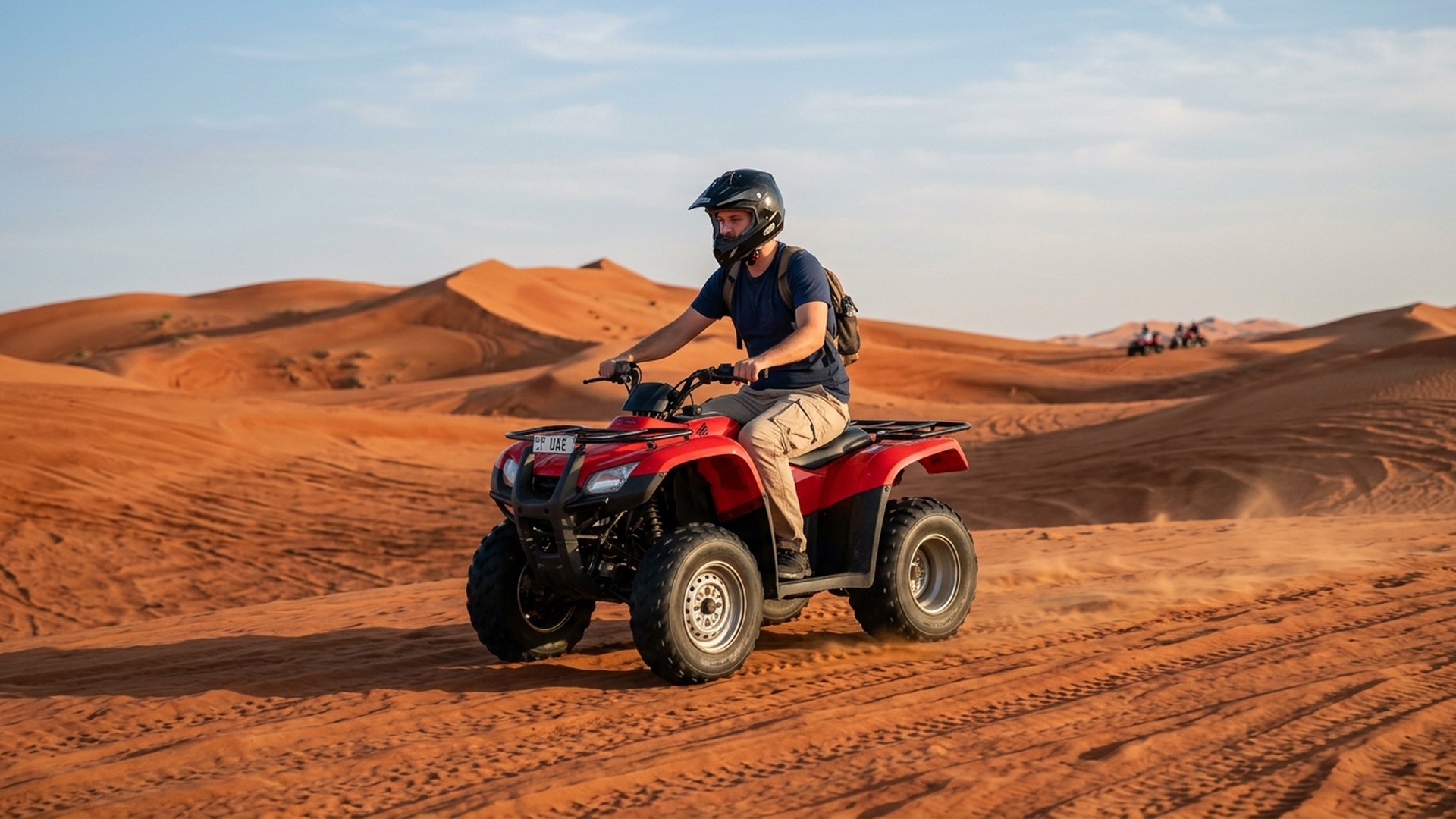 Yamaha quad rider crossing morning red dunes on combo safari