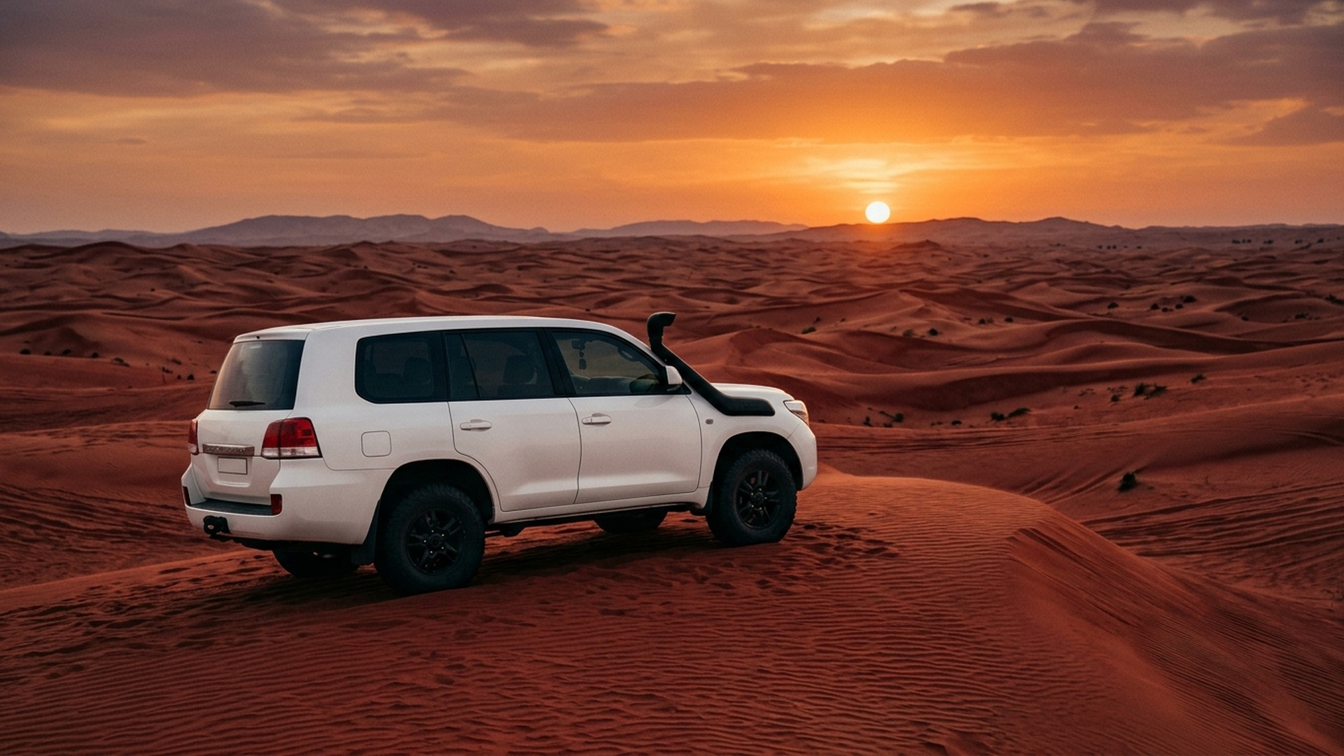 Private 4WD on red Lahbab dune at sunset