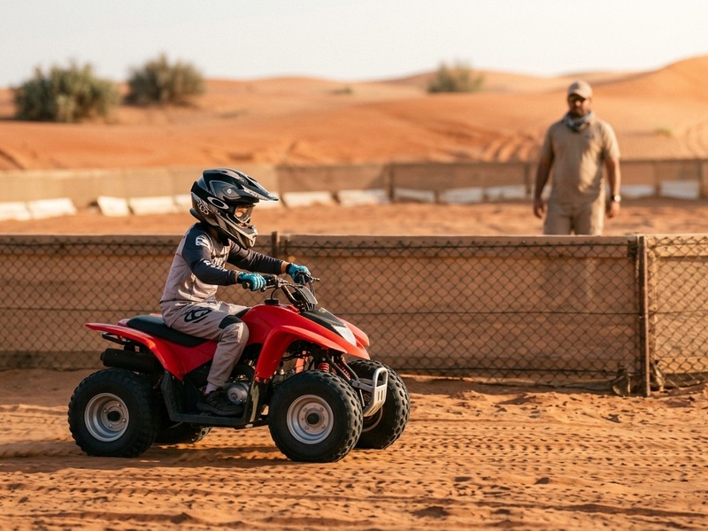 Kids quad bike rider on fenced Lahbab practice loop