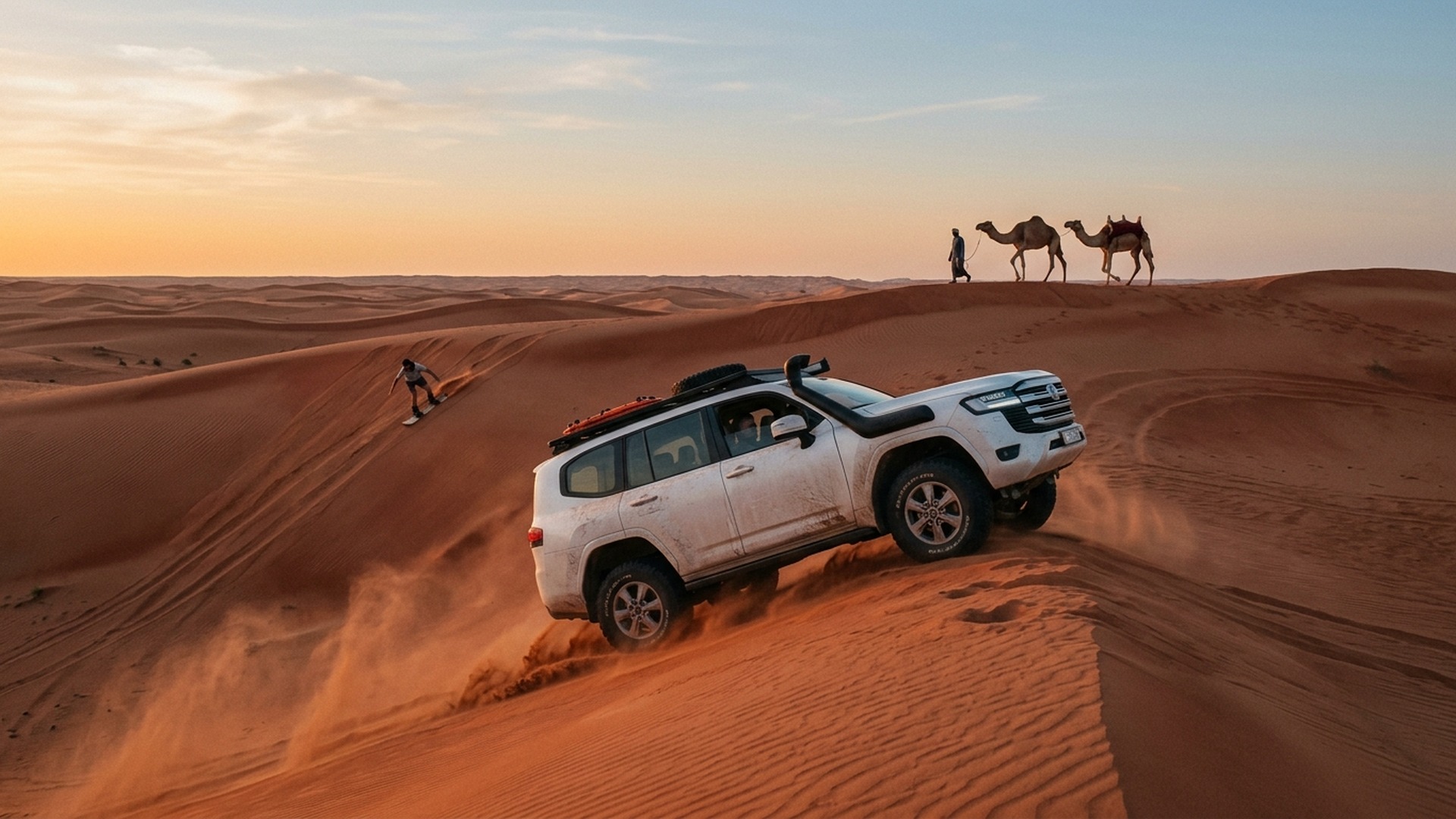 4WD SUV mid dune bash across the red sand of Lahbab Desert at sunrise, Dubai