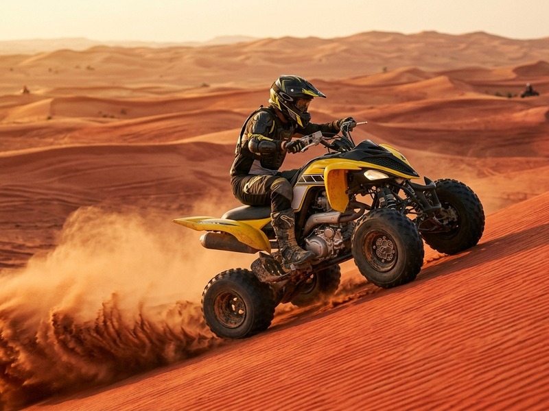 Yamaha Raptor 700 style quad bike rider powering up a Lahbab dune