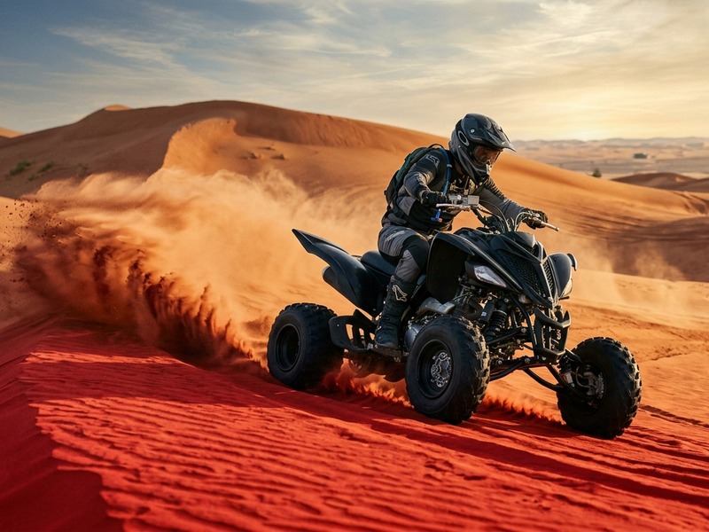 Sports single seater quad bike rider carving through Lahbab sand