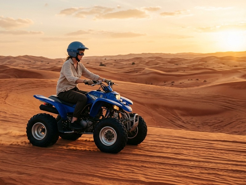 Yamaha quad bike rider crossing open Lahbab dunes